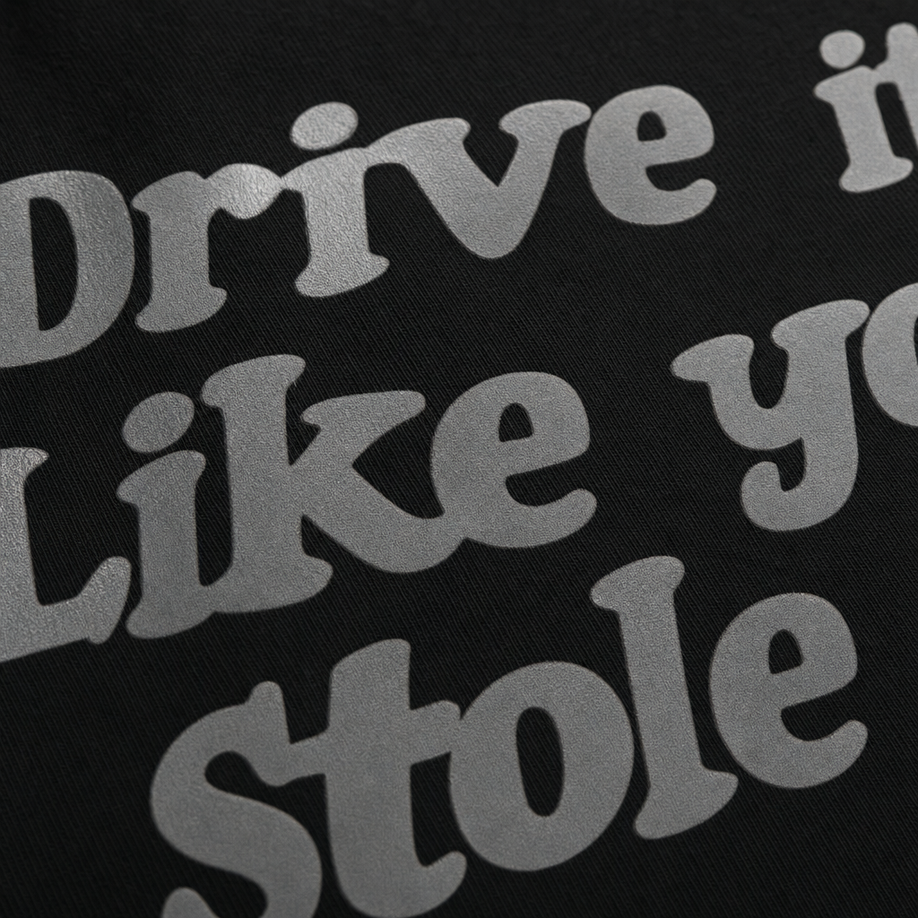 Close-up fabric detail - DRIVE IT LIKE YOU STOLE IT BLACK T-SHIRT